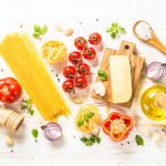 Italian food background at white bkitchen table